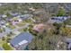 High angle shot of a tile roof home in a mature neighborhood, lush landscaping and paver driveway at 809 Royal Dr, Largo, FL 33770