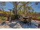 Outdoor space with a dining set, patio heater, mature trees, and fenced yard at 809 Royal Dr, Largo, FL 33770
