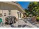 Relaxing backyard patio with brick pavers, lush tropical foliage, and comfortable seating, ideal for enjoying the outdoors at 809 Royal Dr, Largo, FL 33770