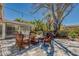 Outdoor patio area featuring wicker seating, a large shade tree, and landscaped surroundings at 809 Royal Dr, Largo, FL 33770