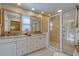 Bathroom featuring double sinks, granite countertops, custom cabinets and a large glass enclosed shower at 809 Royal Dr, Largo, FL 33770