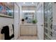Bathroom with well-lit mirror, marble countertops, and modern storage at 809 Royal Dr, Largo, FL 33770
