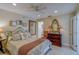 Bright bedroom with a ceiling fan, queen bed, and antique-style dresser at 809 Royal Dr, Largo, FL 33770