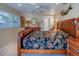 Bedroom with a bed, side tables, ceiling fan, and a window providing natural light at 809 Royal Dr, Largo, FL 33770