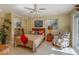 Bedroom showcasing a bed, ceiling fan, closet, and a chair with beach-themed cushions at 809 Royal Dr, Largo, FL 33770