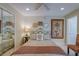 Well-lit bedroom features a queen bed, mirrored closet, and tropical-themed decorations at 809 Royal Dr, Largo, FL 33770