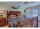 Bedroom showcasing a wooden framed bed, tropical patterned bedding, ceiling fan, and bedside tables at 809 Royal Dr, Largo, FL 33770