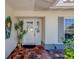 Welcoming front porch with a decorative door, potted plants, and stylish accents, enhancing curb appeal at 809 Royal Dr, Largo, FL 33770