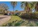 Charming home featuring lush lawn, well-maintained landscaping, paver driveway and tile roof at 809 Royal Dr, Largo, FL 33770