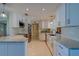 Modern kitchen featuring white cabinetry, stainless steel appliances, and granite countertops at 809 Royal Dr, Largo, FL 33770