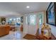 Living room featuring a decorative glass front door, picture windows and terrazzo floor at 809 Royal Dr, Largo, FL 33770