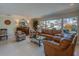 Living room with large window and leather seating and a wooden bar along the wall at 809 Royal Dr, Largo, FL 33770