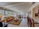 Bright living room with large windows overlooking the patio and bar seating nearby at 809 Royal Dr, Largo, FL 33770