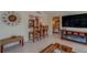 Living room with bar seating, a large clock, a TV, and a glimpse of the adjacent bedroom at 809 Royal Dr, Largo, FL 33770