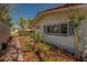 Exterior view of a home with a lush garden, a brick path and a tranquil setting at 809 Royal Dr, Largo, FL 33770