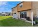 View of the private backyard with a well-maintained lawn, concrete patio, and vinyl fence at 8842 Turnstone Haven Pl, Tampa, FL 33619