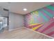 Bedroom featuring colorful mural, modern floors and neutral paint at 8842 Turnstone Haven Pl, Tampa, FL 33619