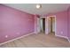 This bedroom has a bright pink wall color and light floors, and a doorway at 8842 Turnstone Haven Pl, Tampa, FL 33619