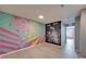 Bedroom featuring chalkboard wall, colorful mural, and modern floors at 8842 Turnstone Haven Pl, Tampa, FL 33619