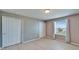 This bedroom features light, neutral walls, new floors, and a window bringing in natural light at 8842 Turnstone Haven Pl, Tampa, FL 33619