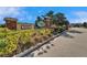 Entrance to Magnolia Park West featuring lush greenery, a brick pillar, and signage at 8842 Turnstone Haven Pl, Tampa, FL 33619