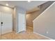 Bright entryway with tile flooring, white doors, and staircase access at 8842 Turnstone Haven Pl, Tampa, FL 33619