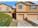 Townhome with a tan exterior and a two-car garage at 8842 Turnstone Haven Pl, Tampa, FL 33619