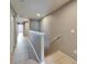 Bright hallway with wood floors, neutral walls, and access to multiple rooms at 8842 Turnstone Haven Pl, Tampa, FL 33619