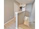 Hallway with wood floors and gray walls, leads to carpeted stairs and closet at 8842 Turnstone Haven Pl, Tampa, FL 33619