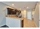 Modern kitchen featuring stainless steel appliances, granite countertops, and dark wood cabinets at 8842 Turnstone Haven Pl, Tampa, FL 33619