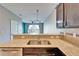 Open kitchen view with bar seating, modern appliances, and view of the living room at 8842 Turnstone Haven Pl, Tampa, FL 33619