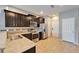 Modern kitchen featuring stainless steel appliances, granite countertops, and dark wood cabinets at 8842 Turnstone Haven Pl, Tampa, FL 33619