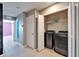 Hallway with laundry featuring modern washer and dryer and a storage closet at 8842 Turnstone Haven Pl, Tampa, FL 33619