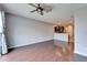 Open living room with hardwood floors and view of the kitchen at 8842 Turnstone Haven Pl, Tampa, FL 33619