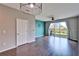 Living room with hardwood floors, sliding glass doors, and a view of the backyard at 8842 Turnstone Haven Pl, Tampa, FL 33619