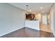 Open-concept living room with dark wood flooring and view of the kitchen at 8842 Turnstone Haven Pl, Tampa, FL 33619