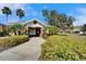 Gated pool entrance with lush landscaping in a well-maintained community at 8842 Turnstone Haven Pl, Tampa, FL 33619