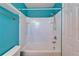 Clean white shower and tub combination with blue accent wall at 8842 Turnstone Haven Pl, Tampa, FL 33619