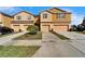 Attached townhomes with garages and well-manicured lawns at 8842 Turnstone Haven Pl, Tampa, FL 33619