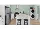 Well-equipped kitchen featuring modern appliances, a center island with seating, and light-green walls at 907 Jones St, Clearwater, FL 33755