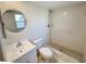 A full bathroom with a white shower, sink, and toilet at 9221 Repondo Pl, New Port Richey, FL 34655