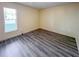 A clean, spacious bedroom with wood-look floors and ample natural light at 9221 Repondo Pl, New Port Richey, FL 34655