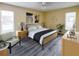 A staged bedroom features a sleek bed frame, stylish decor, and wood-look flooring at 9221 Repondo Pl, New Port Richey, FL 34655
