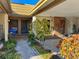 Inviting front entrance with lush landscaping and covered parking at 9221 Repondo Pl, New Port Richey, FL 34655