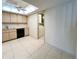 Open kitchen with light wood cabinets and adjacent laundry area enhances functionality at 9221 Repondo Pl, New Port Richey, FL 34655