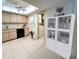 Eat-in kitchen with a white hutch and adjacent laundry area enhances functionality at 9221 Repondo Pl, New Port Richey, FL 34655