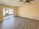 Bright and airy living room with sleek floors and a view of the screened lanai at 9221 Repondo Pl, New Port Richey, FL 34655