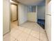 A versatile room features tile flooring and access to additional spaces at 9221 Repondo Pl, New Port Richey, FL 34655