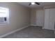 Simple bedroom featuring tile floors, a ceiling fan with light, and a double-door closet at 9412 N Elmer St, Tampa, FL 33612