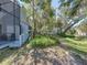 View of a home's backyard featuring an outdoor seating area and green surroundings at 9718 Tiffany Oaks Ln # 12, Tampa, FL 33612